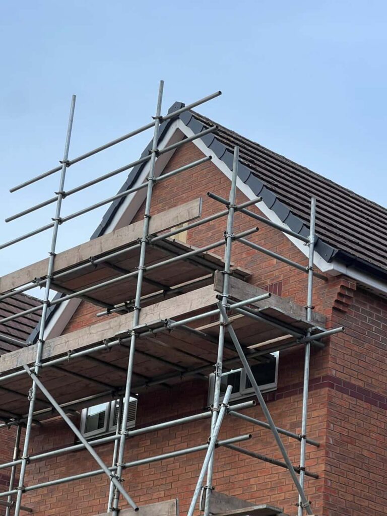 This is a photo of a roof which has just been repaired. There is a scaffold located at the gable end for access onto the roof. Works carried out by March Roofing Repairs